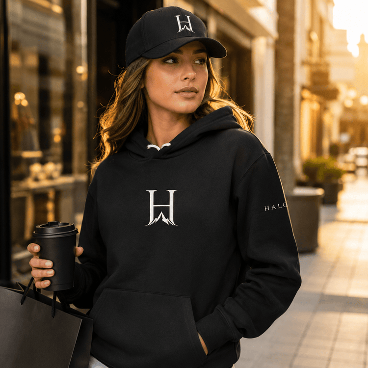 Woman wearing a black Higher House cap and hoodie | Hats and Accessories Collection