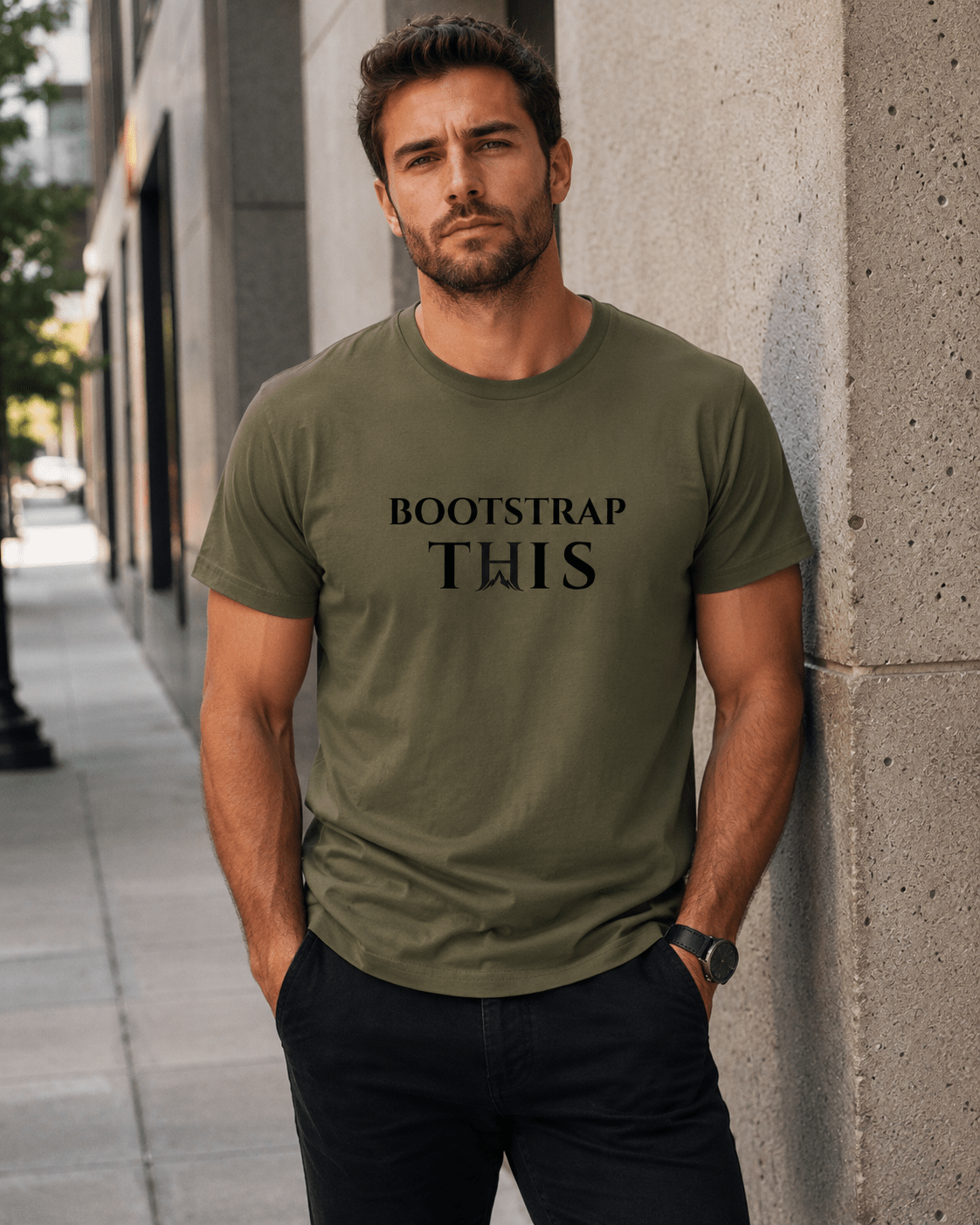 Man wearing the Army Bootstrap This Men’s Tee — Black Edition with black artwork beside a concrete wall