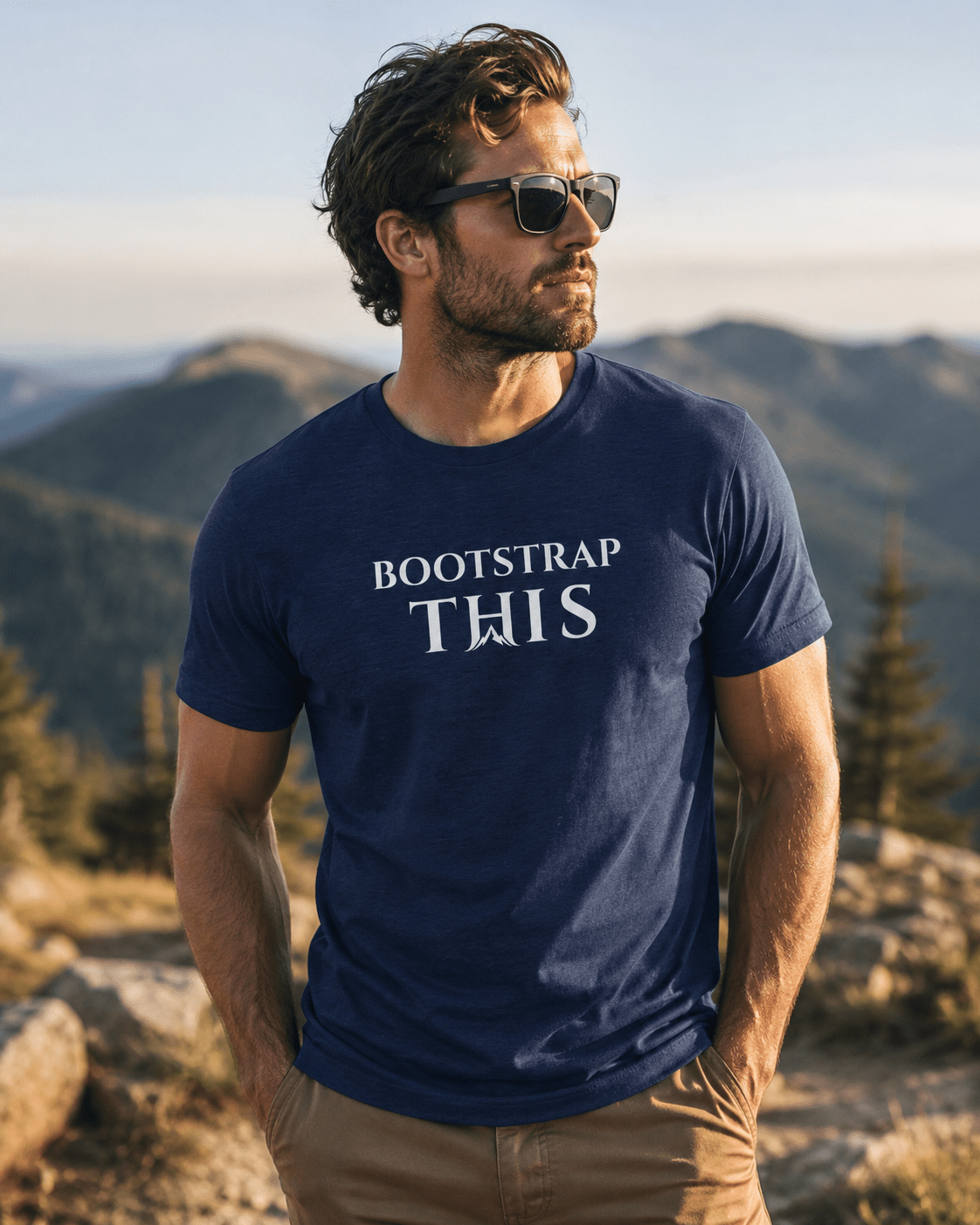 Bootstrap This Men's Tee — White Edition, model wearing the Heather Midnight Navy tee on a city sidewalk.