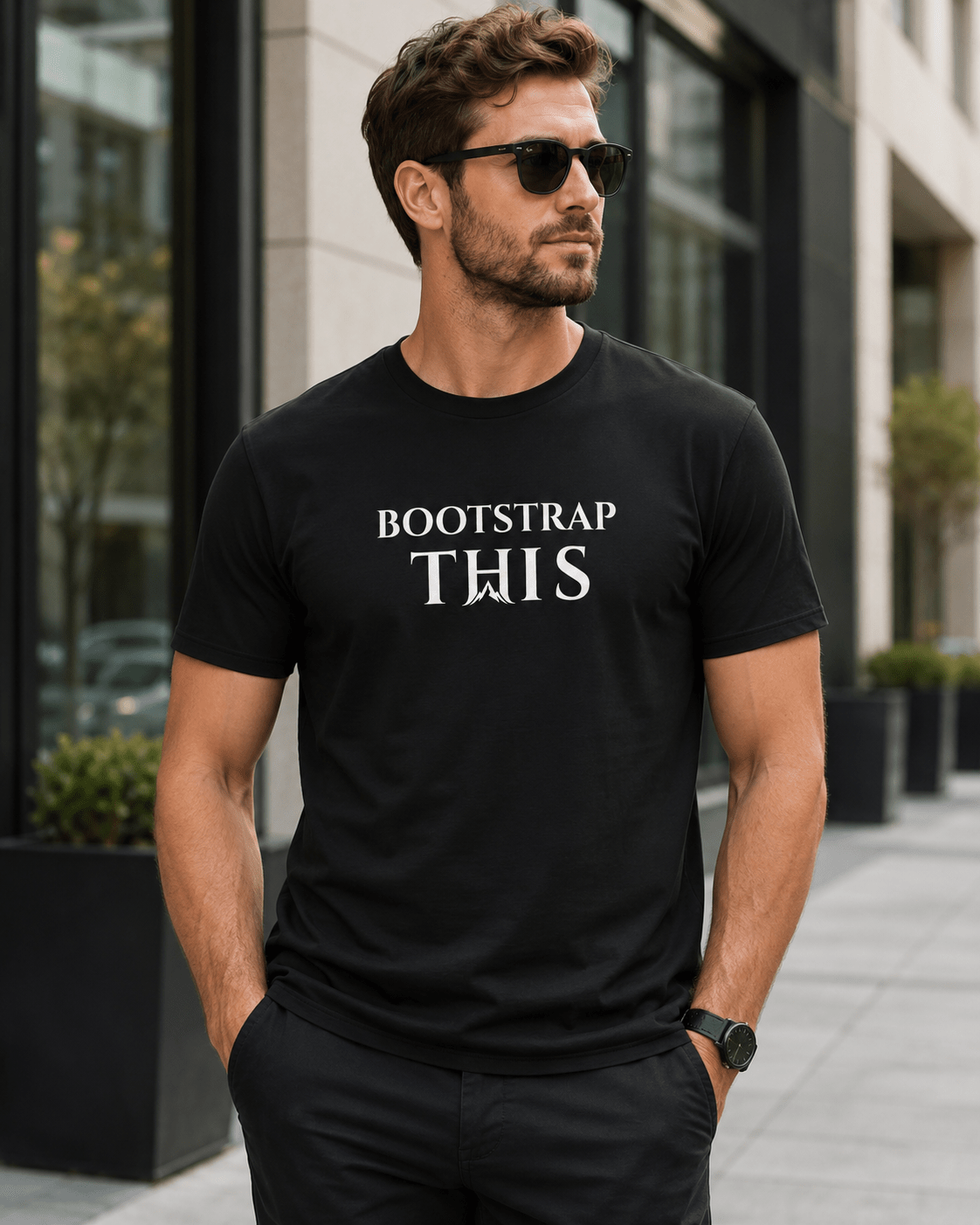 Bootstrap This Men's Tee — White Edition, model wearing the Vintage Black tee at a mountain overlook.