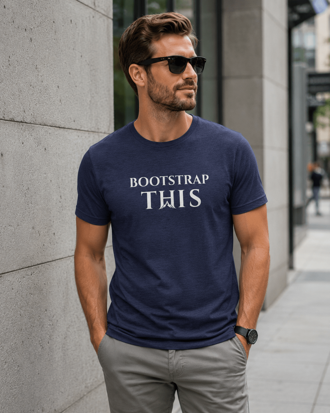 Bootstrap This Men's Tee — White Edition, model wearing the Heather Midnight Navy tee on a city rooftop.