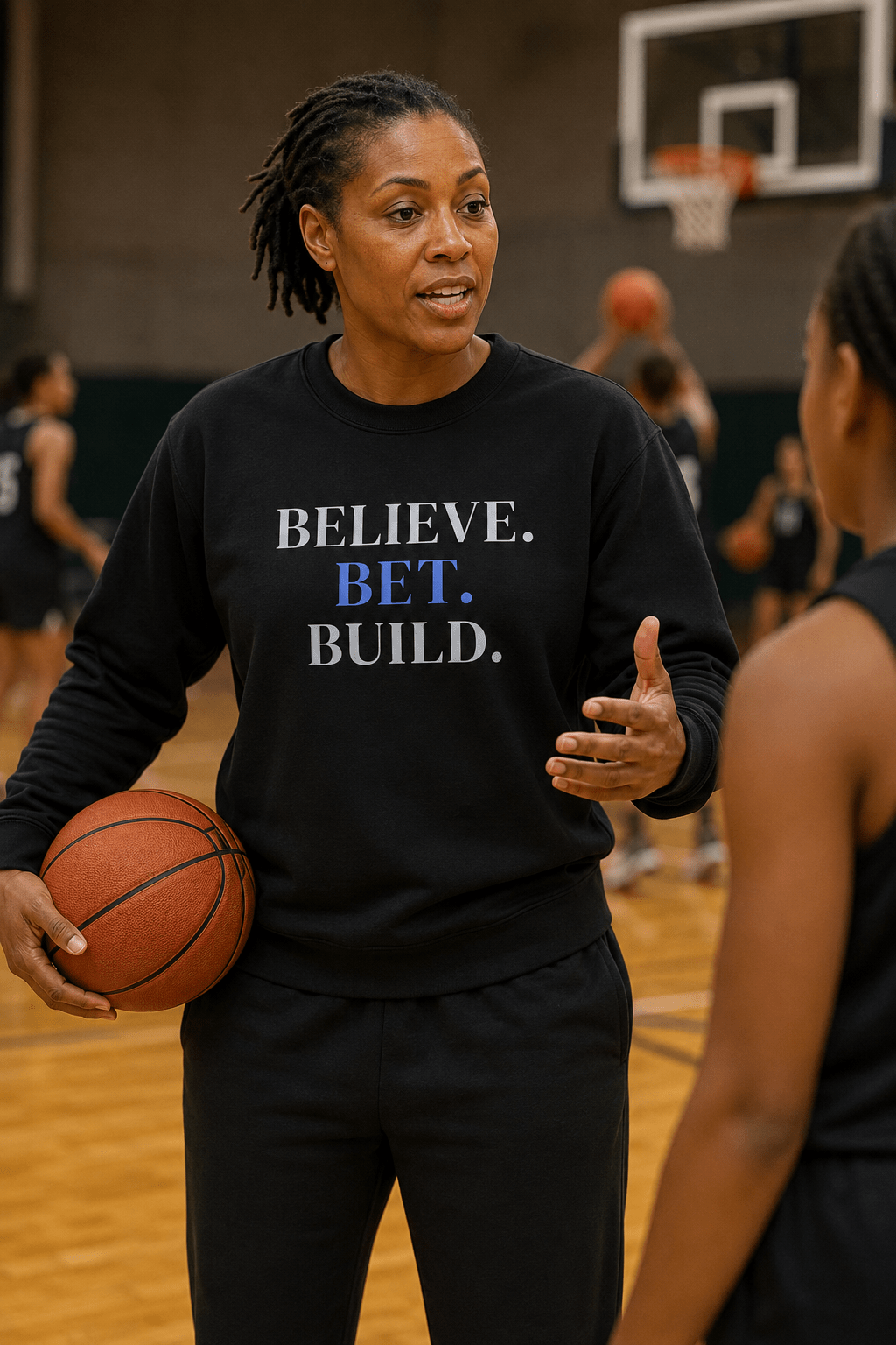 Black Bootstrappin’ BELIEVE. BET. BUILD. crewneck — model holding a basketball