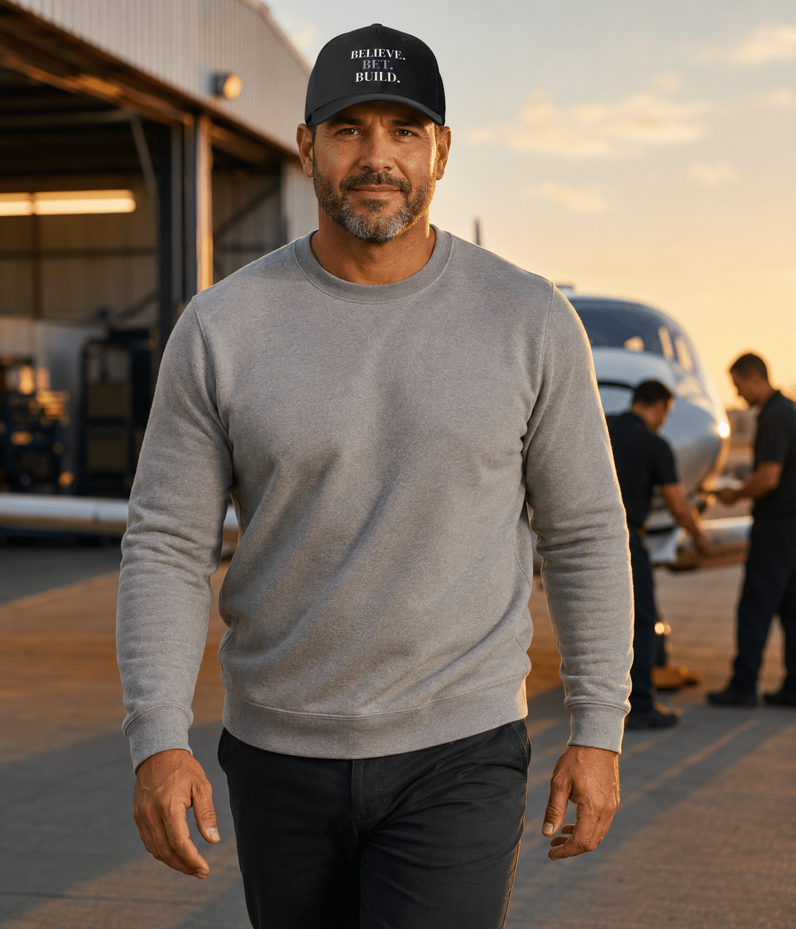 Black Bootstrappin’ BELIEVE. BET. BUILD. Flexfit cap — model outdoors