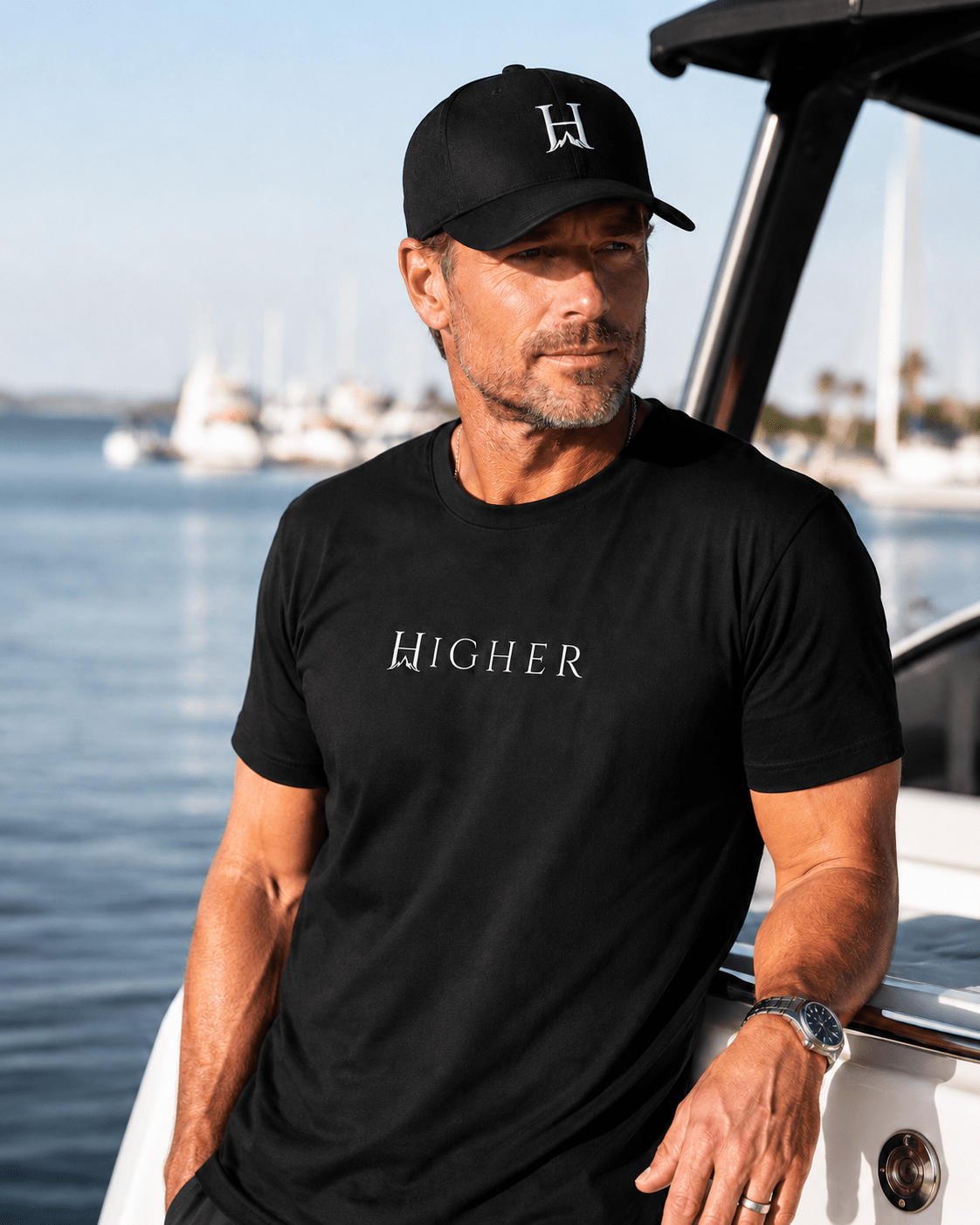 Notorious Flexfit Cap, model wearing the Notorious cap with a Darkborne HIGHER Tee by the water.