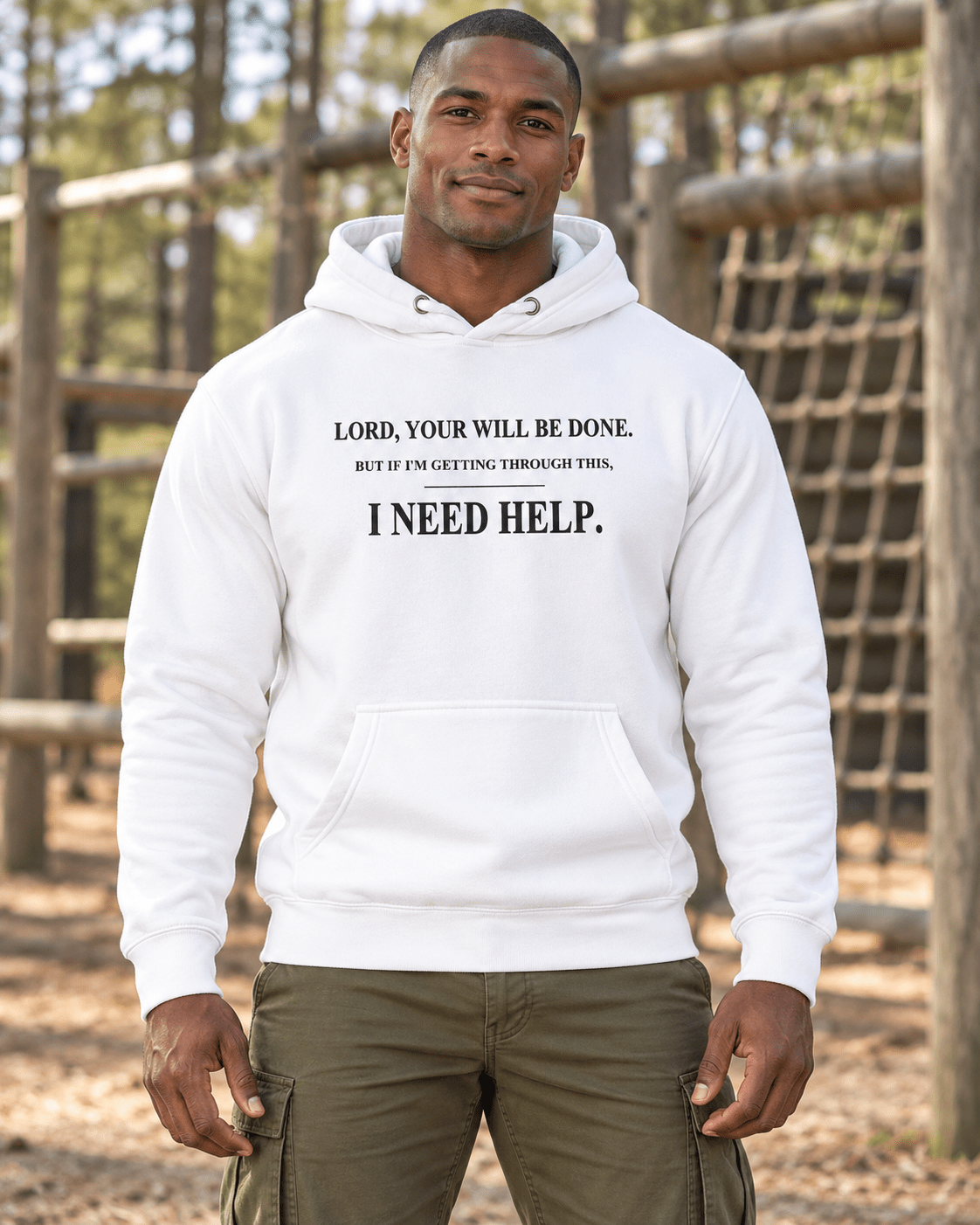 Man at an outdoor training course wearing a White DESCENT faith hoodie, front view showing Your Will Be Done and I Need Help lettering