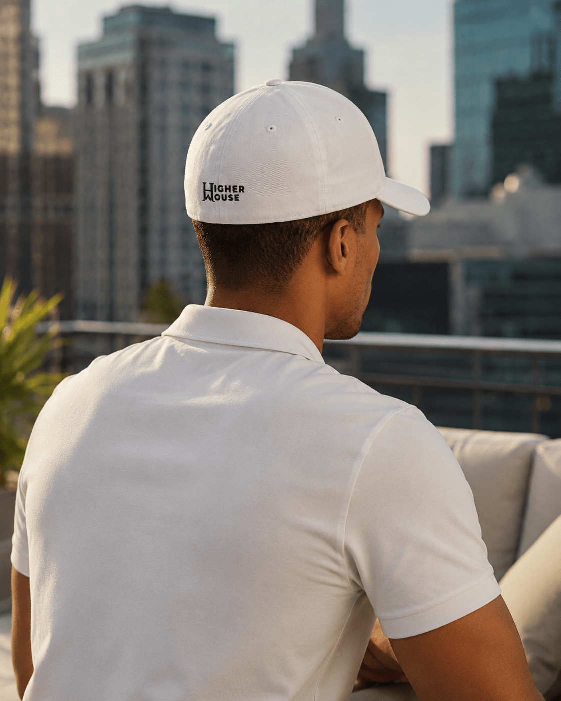 Heritage Flexfit Cap, model wearing the White cap, back view in the city.