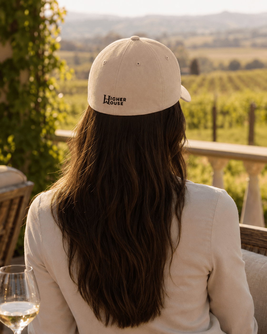 Heritage Flexfit Cap, model wearing the White cap, back view outdoors.