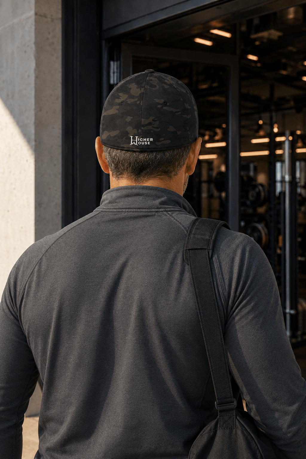 Notorious Flexfit Cap, model wearing the dark cap at an overlook.