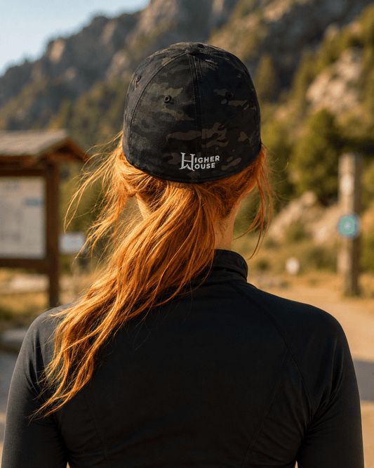 Notorious Flexfit Cap, model wearing the dark cap outdoors.