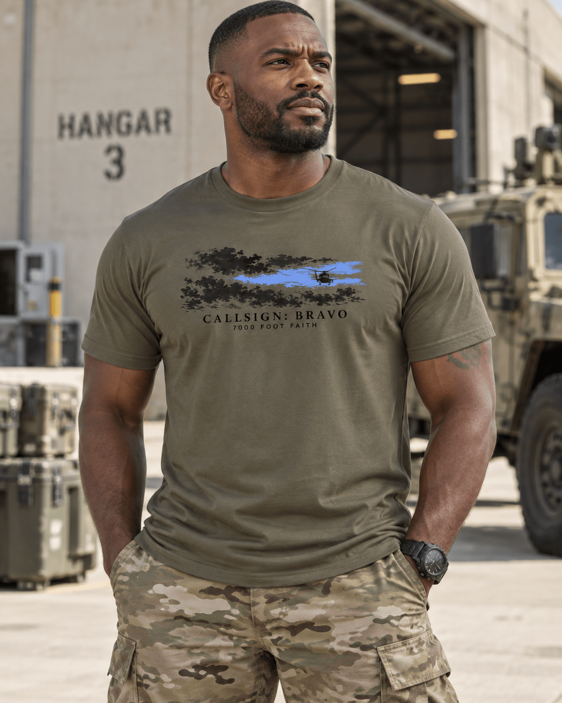 Army The Opening CALLSIGN: BRAVO tee — male model near a hangar, front view