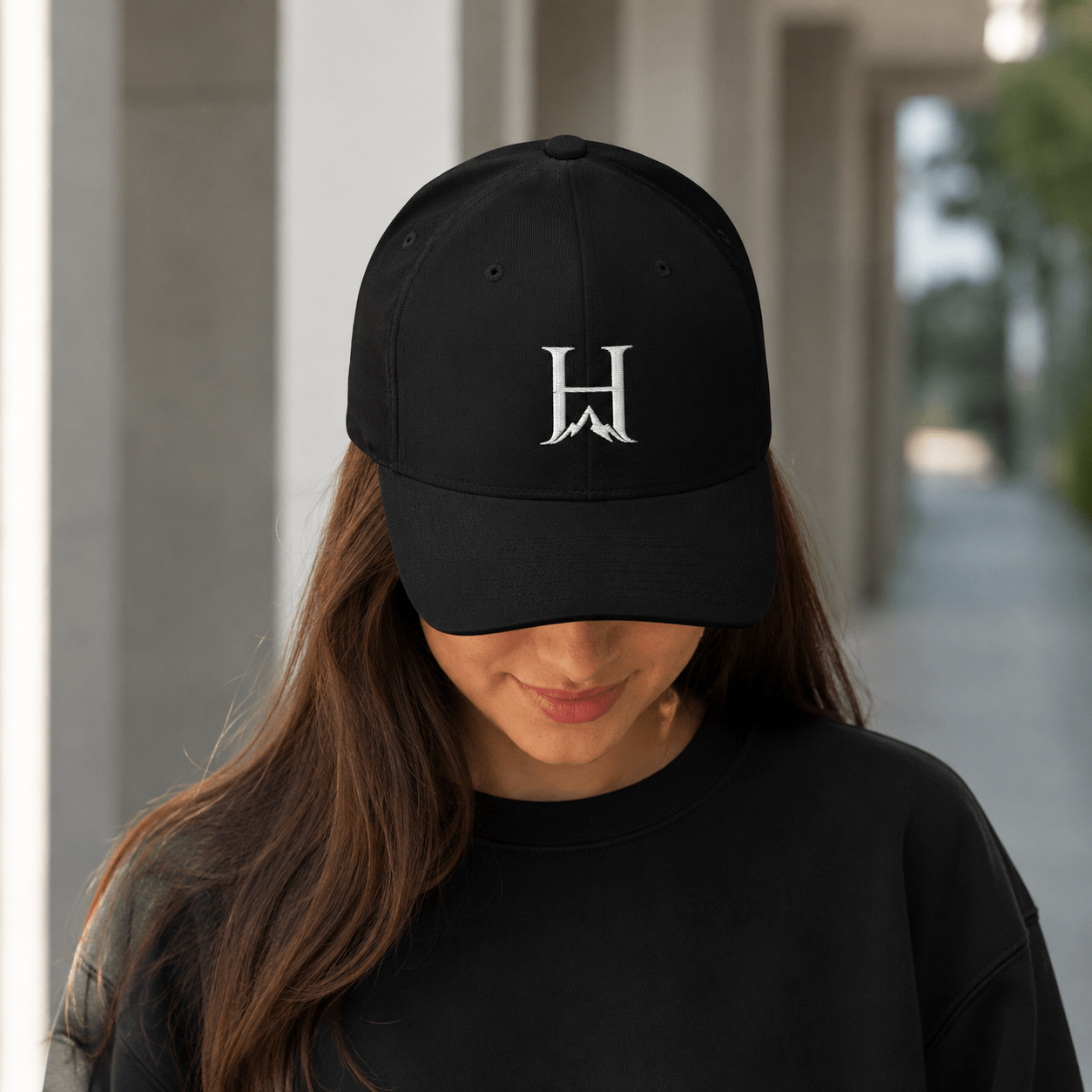 Notorious Flexfit Cap, model wearing the dark cap outdoors.