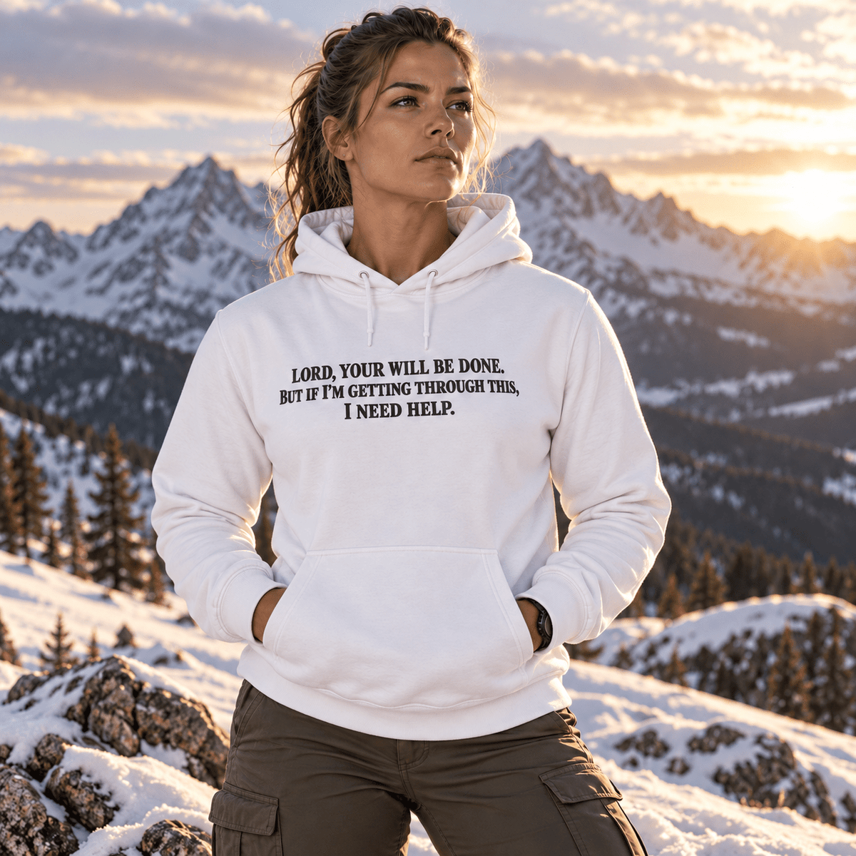 Woman wearing a White Your Will Be Done: Descent CALLSIGN: BRAVO hoodie in snowy mountains — front view