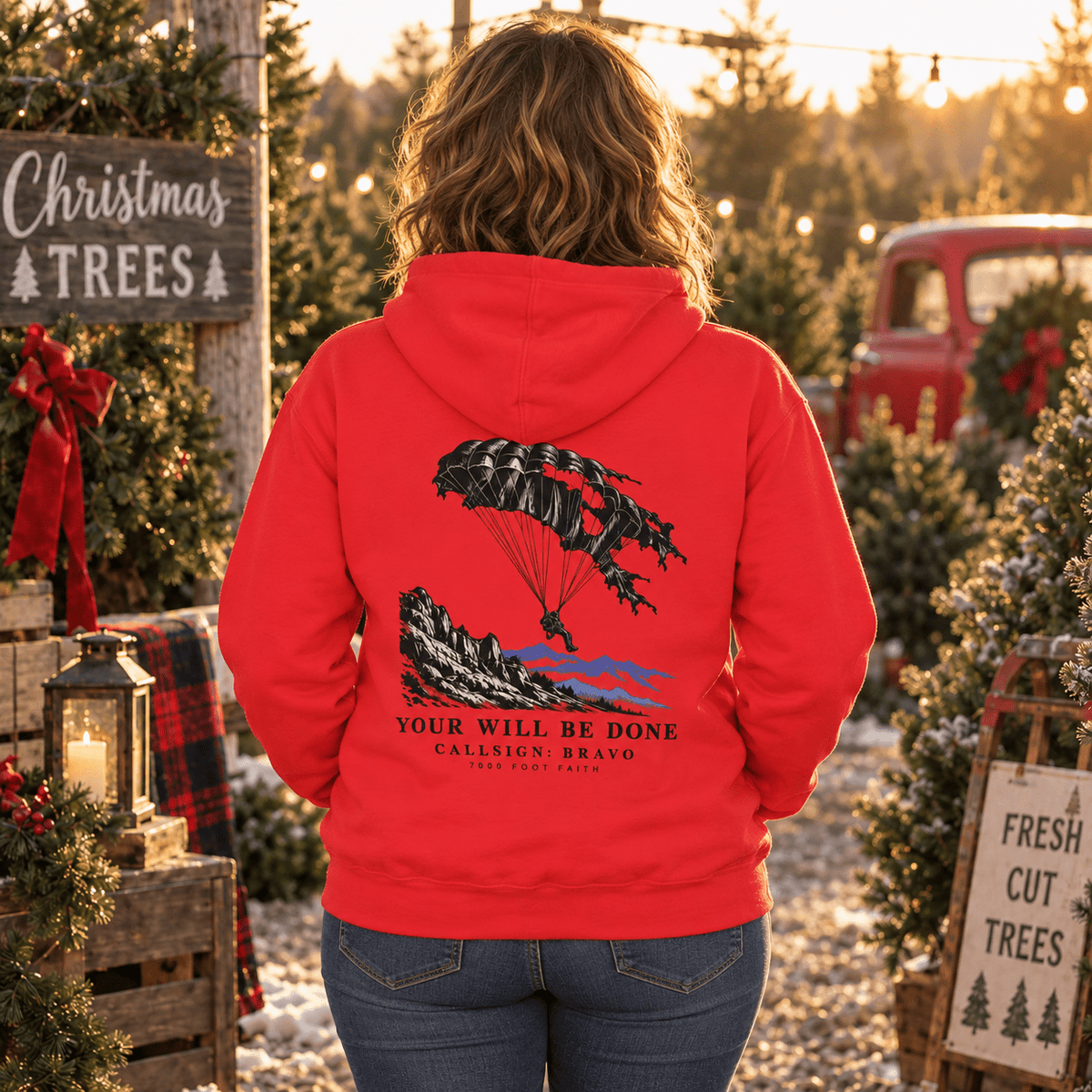 Woman wearing a Team Red Your Will Be Done: Descent CALLSIGN: BRAVO hoodie at a Christmas tree lot — back view