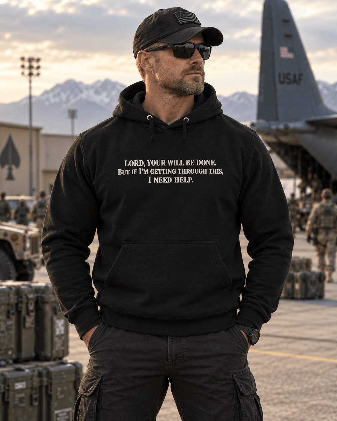 Man wearing a Black Your Will Be Done: Descent CALLSIGN: BRAVO hoodie on an airfield — front view