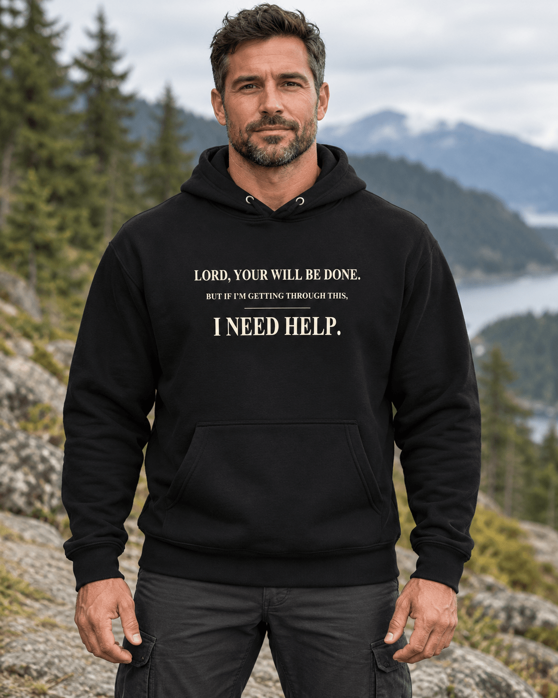 Man outdoors wearing a Black DESCENT faith hoodie, front view showing Your Will Be Done and I Need Help lettering