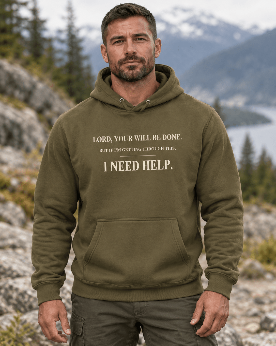 Man outdoors wearing a Military Green DESCENT faith hoodie, front view showing Your Will Be Done and I Need Help lettering