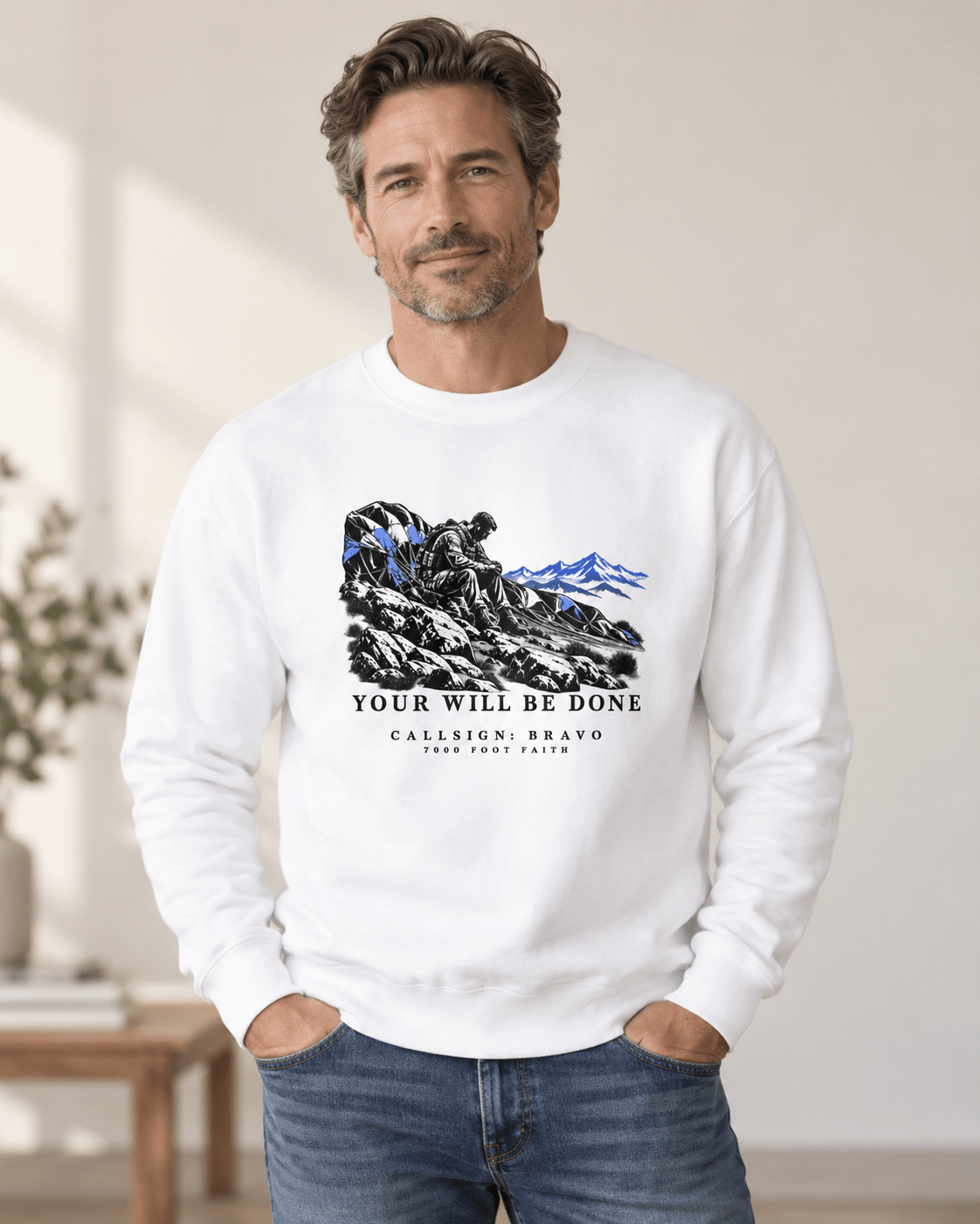Man wearing a White Your Will Be Done: The Aftermath CALLSIGN: BRAVO crewneck indoors — front view