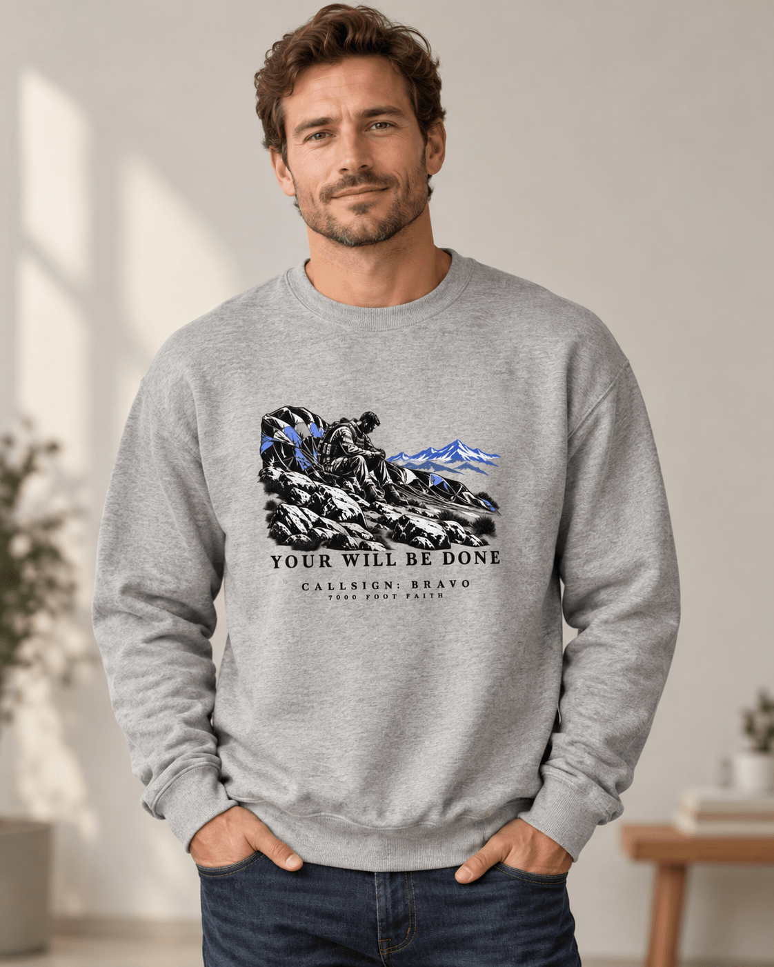 Man wearing a Carbon Grey Your Will Be Done: The Aftermath CALLSIGN: BRAVO crewneck indoors — front view