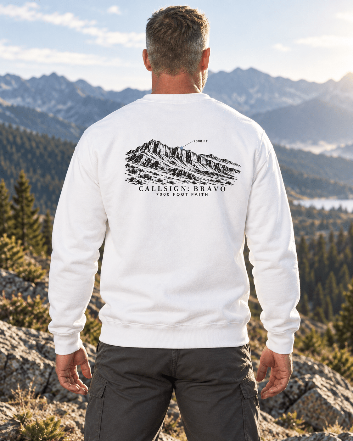 White Zagros Ridgeline CALLSIGN: BRAVO crewneck — male model in mountains, back view
